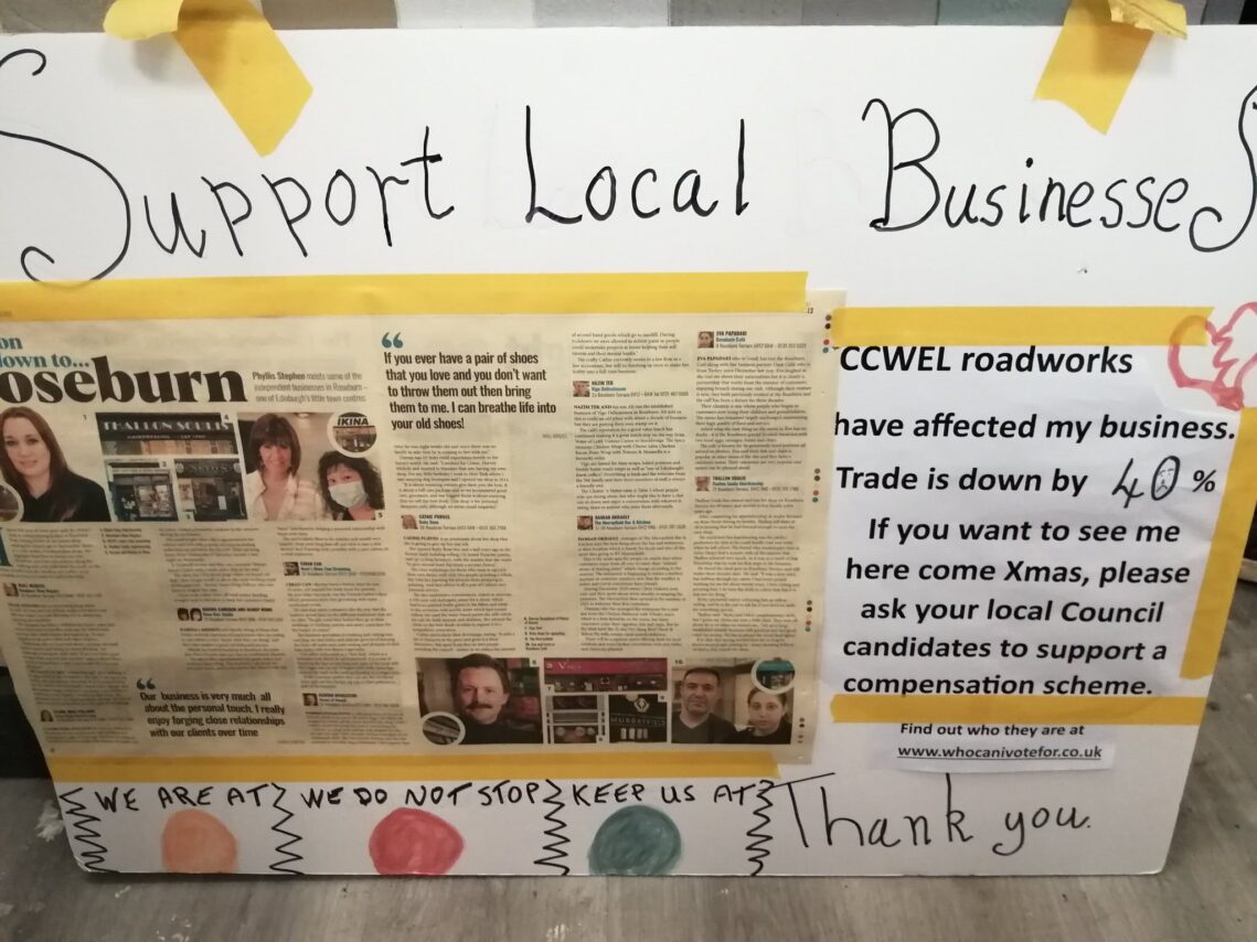 Billboard poster campaigning for support for Roseburn business following road disruption from cycle lane roadworks