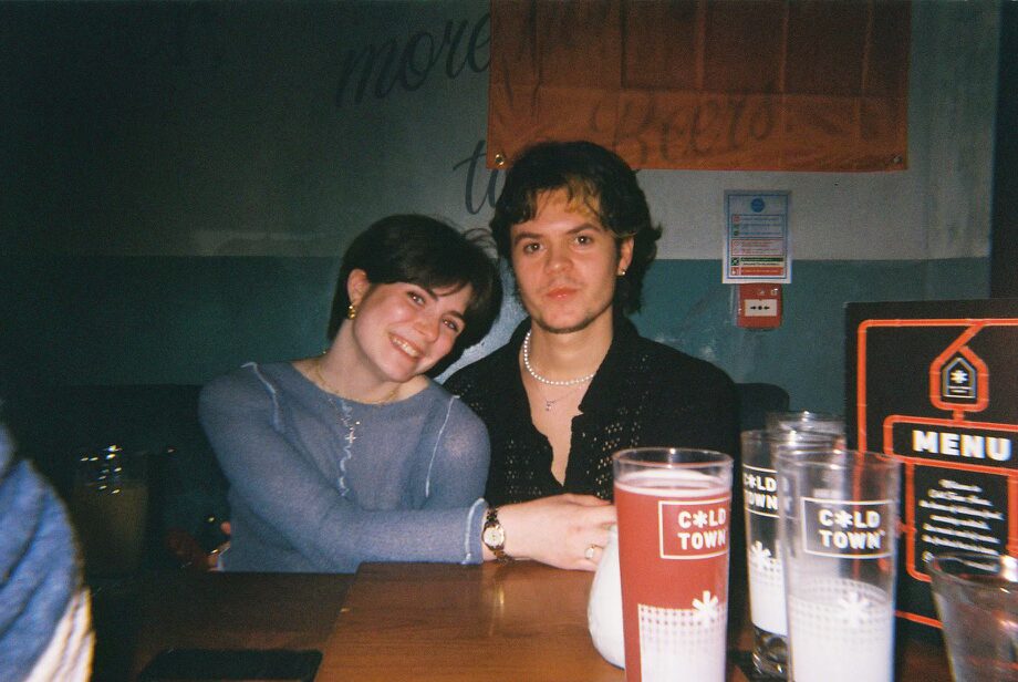 Two people in a bar smiling